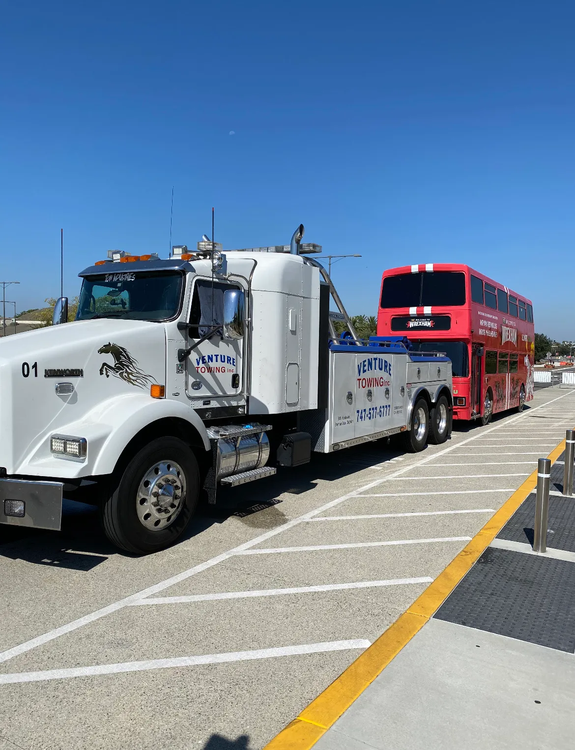 Venture Towing heavy duty tow truck hauling a big rig